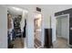 Hallway leading to a walk-in closet and a bathroom featuring a vanity and a shower with striped curtains at 5501 80Th N St # 201, St Petersburg, FL 33709