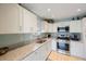 Modern kitchen featuring white cabinets, granite countertops, and stainless steel appliances at 5501 80Th N St # 201, St Petersburg, FL 33709