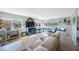 Bright living room featuring oversized windows with bench seats and wood laminate flooring at 5501 80Th N St # 201, St Petersburg, FL 33709