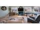 Inviting living room featuring large windows, wood laminate flooring, and a comfortable seating area at 5501 80Th N St # 201, St Petersburg, FL 33709