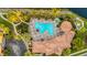 Aerial view of a community pool area surrounded by lush landscaping at 606 Riviera Dunes Way # 207, Palmetto, FL 34221