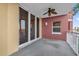 This spacious balcony features a ceiling fan and access via sliding glass doors to the interior at 606 Riviera Dunes Way # 207, Palmetto, FL 34221