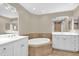 Bathroom featuring a soaking tub with tile surround, double vanities, and neutral tones at 606 Riviera Dunes Way # 207, Palmetto, FL 34221