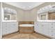 Bathroom showcasing a soaking tub, double vanities, and neutral tones at 606 Riviera Dunes Way # 207, Palmetto, FL 34221