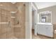 Bathroom featuring a glass shower and a vanity with ample counter space at 606 Riviera Dunes Way # 207, Palmetto, FL 34221