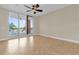 Bedroom with ceiling fan and glass doors opening to balcony with waterfront views at 606 Riviera Dunes Way # 207, Palmetto, FL 34221