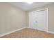 Neutral bedroom with tile floor, baseboards, and closet with sliding doors at 606 Riviera Dunes Way # 207, Palmetto, FL 34221