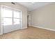 The neutral bedroom has tile floors, a window, and a closet at 606 Riviera Dunes Way # 207, Palmetto, FL 34221