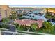Beautiful clubhouse with red tile roof, palm trees, and a pool, creating a resort-style atmosphere at 606 Riviera Dunes Way # 207, Palmetto, FL 34221