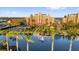 Beautiful condo community with tropical landscaping, a pond with fountain, and tennis court at 606 Riviera Dunes Way # 207, Palmetto, FL 34221