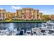 Condo building with a marina and boats docked in front of the building at 606 Riviera Dunes Way # 207, Palmetto, FL 34221