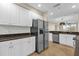 Bright kitchen features stainless steel appliances, granite countertops and ceramic tile flooring at 606 Riviera Dunes Way # 207, Palmetto, FL 34221