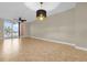 Spacious living room with tile flooring and sliding glass doors to balcony at 606 Riviera Dunes Way # 207, Palmetto, FL 34221