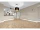 Open living space with tile floors, neutral paint, and access to the kitchen at 606 Riviera Dunes Way # 207, Palmetto, FL 34221