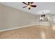 Open living space with access to the kitchen, neutral colors, and tile floors at 606 Riviera Dunes Way # 207, Palmetto, FL 34221