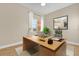 Office with a modern wood desk, contemporary art, and a comfortable chair at 606 Riviera Dunes Way # 207, Palmetto, FL 34221
