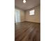 Cozy bedroom featuring wood-look flooring, clean walls, and a bright window at 1405 E Jean St, Tampa, FL 33604