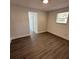 Spacious bedroom showcasing new flooring, fresh paint, and natural light from a window at 1405 E Jean St, Tampa, FL 33604