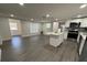 Modern kitchen featuring an island, stainless steel appliances, and sleek gray flooring at 1405 E Jean St, Tampa, FL 33604