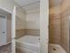 Bathroom with a separate shower and a large bathtub, accented with decorative tile at 3108 Magnolia Garden Dr, Plant City, FL 33567