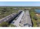 Scenic aerial view showcases a well-maintained community with lush greenery and a peaceful lake nearby at 2210 Utopian E Dr # 314, Clearwater, FL 33763