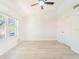Bright bedroom with a ceiling fan, large window providing natural light, and neutral flooring at 2210 Utopian E Dr # 314, Clearwater, FL 33763