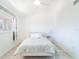Bedroom with updated floors, white walls and a window with curtains at 2210 Utopian E Dr # 314, Clearwater, FL 33763