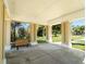 A sheltered bench seating area surrounded by trees and lush landscaping at 2210 Utopian E Dr # 314, Clearwater, FL 33763