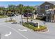 Community entrance featuring decorative signage, landscaping, and multiple parking spots at 2210 Utopian E Dr # 314, Clearwater, FL 33763