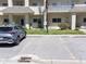 Well maintained condo exterior featuring ample parking, landscaping, and neutral tones at 2210 Utopian E Dr # 314, Clearwater, FL 33763
