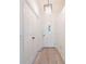 Hallway featuring wood-style flooring and an exterior door with decorative glass at 2210 Utopian E Dr # 314, Clearwater, FL 33763