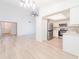 Open-concept living space featuring a kitchen with stainless steel appliances and modern white cabinets at 2210 Utopian E Dr # 314, Clearwater, FL 33763