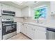 Well-lit kitchen featuring a stainless steel oven and modern appliances at 2210 Utopian E Dr # 314, Clearwater, FL 33763