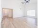 Spacious living room with wood flooring, high ceilings, and modern ceiling fan at 2210 Utopian E Dr # 314, Clearwater, FL 33763