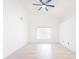 Spacious living room with wood floors, high ceilings, and a modern ceiling fan at 2210 Utopian E Dr # 314, Clearwater, FL 33763