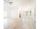 Bright and airy living room featuring wood-style flooring and a modern ceiling fan at 2210 Utopian E Dr # 314, Clearwater, FL 33763