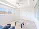 Bright living room with built-in bookshelves, large window, ceiling fan, and comfortable furniture at 2210 Utopian E Dr # 314, Clearwater, FL 33763
