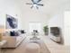 Bright and open living room with a large window, high ceilings, and wood flooring at 2210 Utopian E Dr # 314, Clearwater, FL 33763