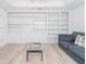 Bright living room showcases built-in shelving and sleek furniture, offering a modern and functional space at 2210 Utopian E Dr # 314, Clearwater, FL 33763