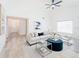 Living room featuring an open floor plan with wood floors and ample natural light at 2210 Utopian E Dr # 314, Clearwater, FL 33763