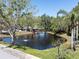 Scenic pond surrounded by lush greenery, including trees and palm trees at 2210 Utopian E Dr # 314, Clearwater, FL 33763