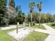 Recreation area with horseshoe pits, walking path, and palm trees at 2210 Utopian E Dr # 314, Clearwater, FL 33763