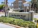 Community sign surrounded by lush landscaping and manicured greenery at 2210 Utopian E Dr # 314, Clearwater, FL 33763