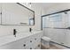 Modern bathroom features double vanity, contemporary fixtures, and glass enclosed shower with sleek, black hardware at 2503 Dumont Ln, North Port, FL 34286