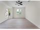 Bright, empty bedroom with wood floors, large windows, and a ceiling fan offering a clean and spacious feel at 2503 Dumont Ln, North Port, FL 34286