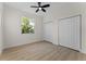 Bright bedroom features modern ceiling fan, natural light from window and multiple closets for optimal storage space at 2503 Dumont Ln, North Port, FL 34286
