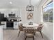 Cozy dining nook featuring modern lighting and a view to the kitchen appliances at 2503 Dumont Ln, North Port, FL 34286