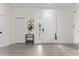 Welcoming entryway with white door, neutral walls, and a decorative display table at 2503 Dumont Ln, North Port, FL 34286