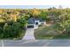 Home exterior showing driveway, garage and mature landscaping at 2503 Dumont Ln, North Port, FL 34286