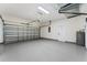 Spacious garage with high ceilings, smooth flooring, and ample room for parking and storage solutions at 2503 Dumont Ln, North Port, FL 34286